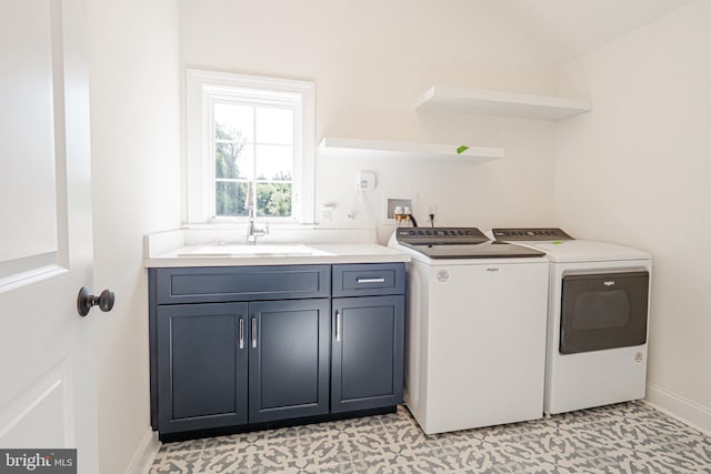 washroom featuring separate washer and dryer, sink, light tile patterned floors, and cabinets