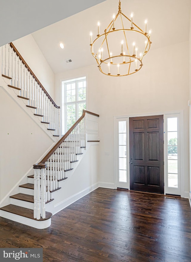 entrance foyer with dark wood-type flooring and a high ceiling