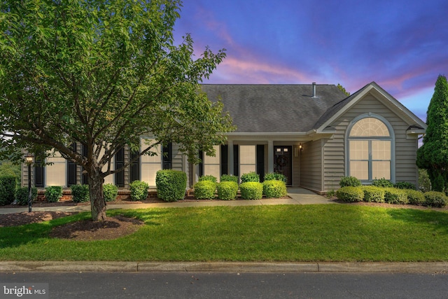 view of front of property with a lawn