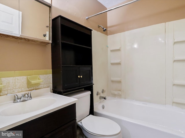 full bathroom with bathtub / shower combination, vanity, tasteful backsplash, and toilet