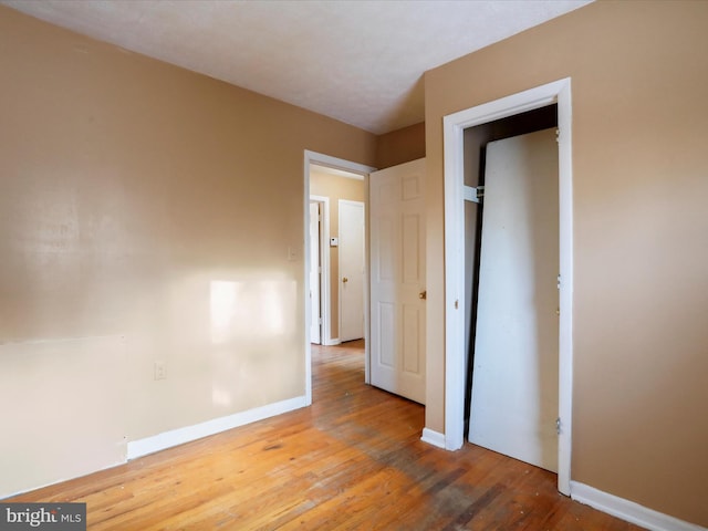 unfurnished bedroom featuring hardwood / wood-style flooring