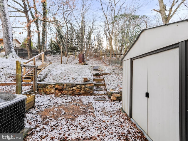 snowy yard featuring central AC unit