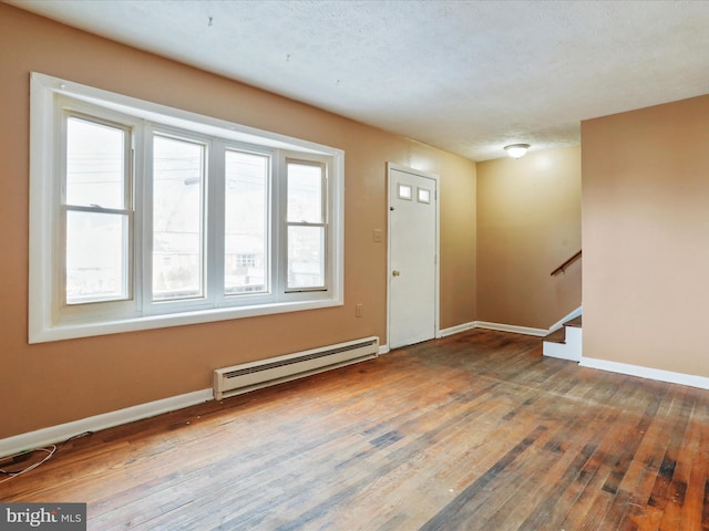 foyer featuring a textured ceiling, a baseboard radiator, and hardwood / wood-style flooring