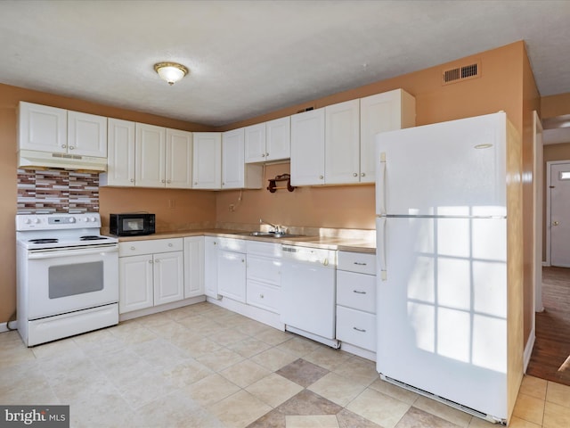 kitchen featuring sink, white cabinets, and white appliances