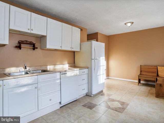 kitchen with white cabinets, white appliances, and sink