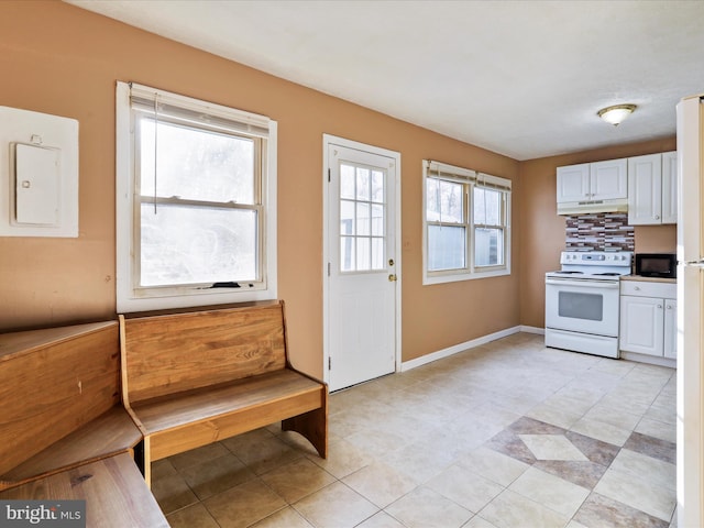 kitchen featuring white electric range oven, decorative backsplash, electric panel, and white cabinets