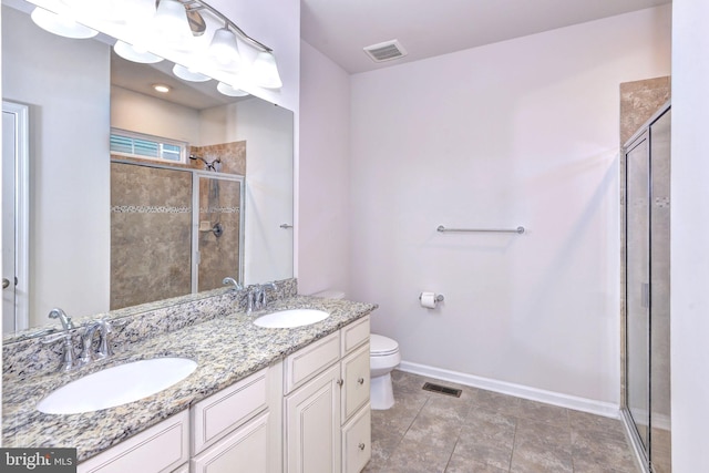 bathroom featuring vanity, an enclosed shower, and toilet