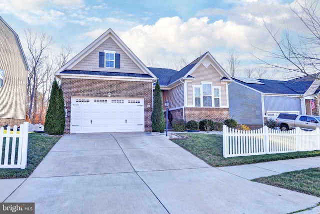 craftsman-style home with a garage and a front yard