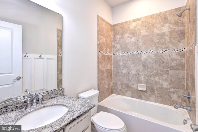 full bathroom with vanity, toilet, and tiled shower / bath