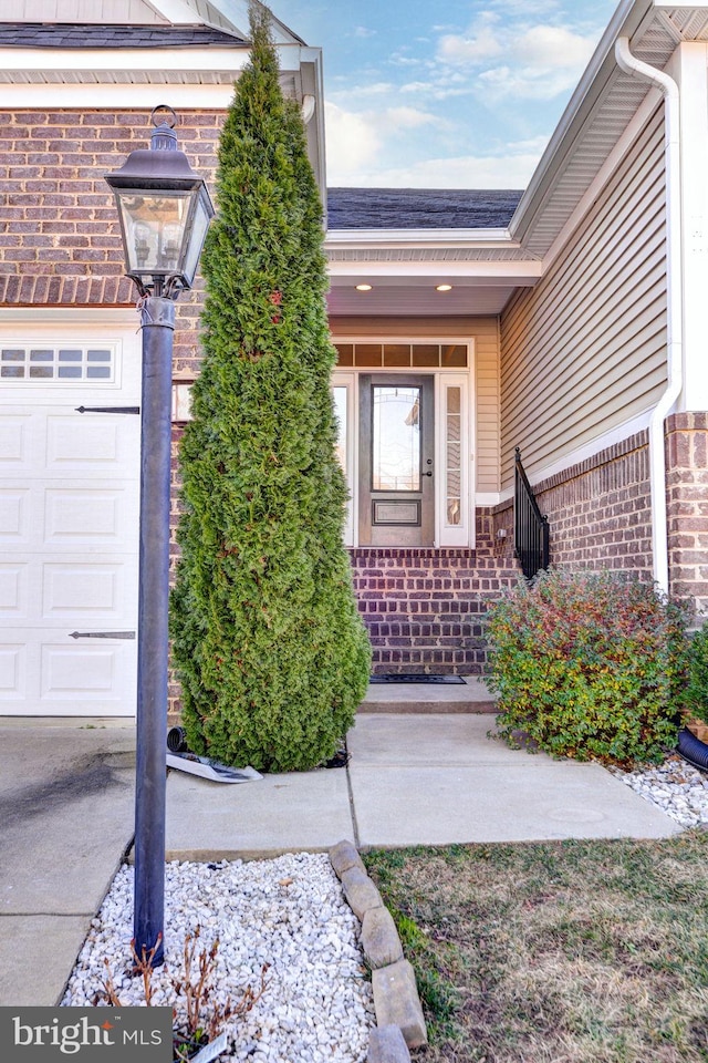 view of exterior entry with a garage