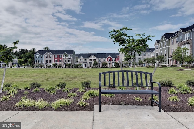 view of home's community with a yard