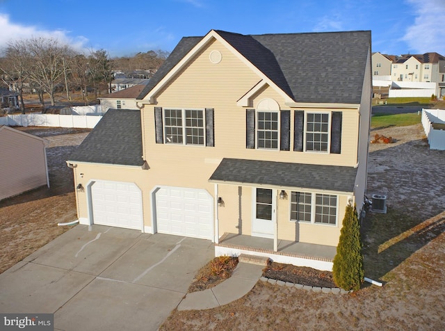 view of front facade with central AC and a garage