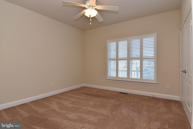 empty room featuring ceiling fan and carpet floors