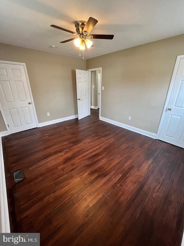 unfurnished bedroom featuring ceiling fan and dark hardwood / wood-style floors