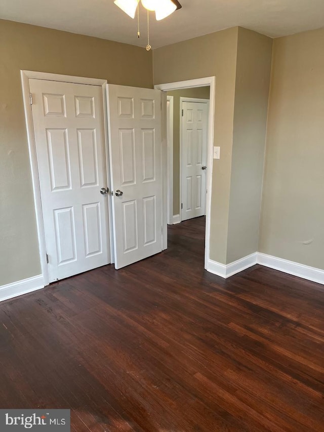 unfurnished bedroom featuring dark wood-type flooring