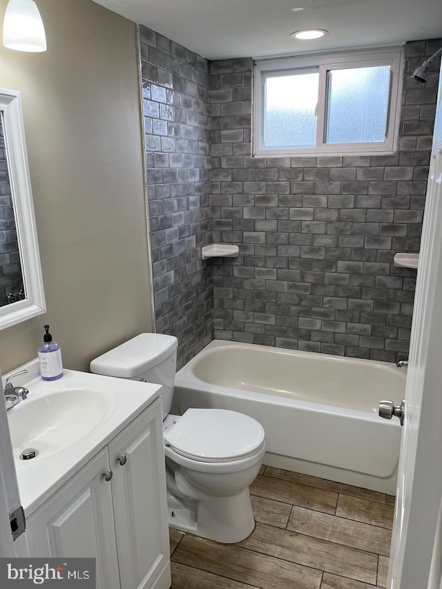 full bathroom featuring vanity, toilet, and tiled shower / bath combo