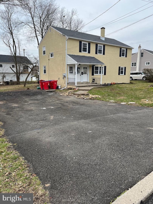 view of front of house with a porch and a front lawn