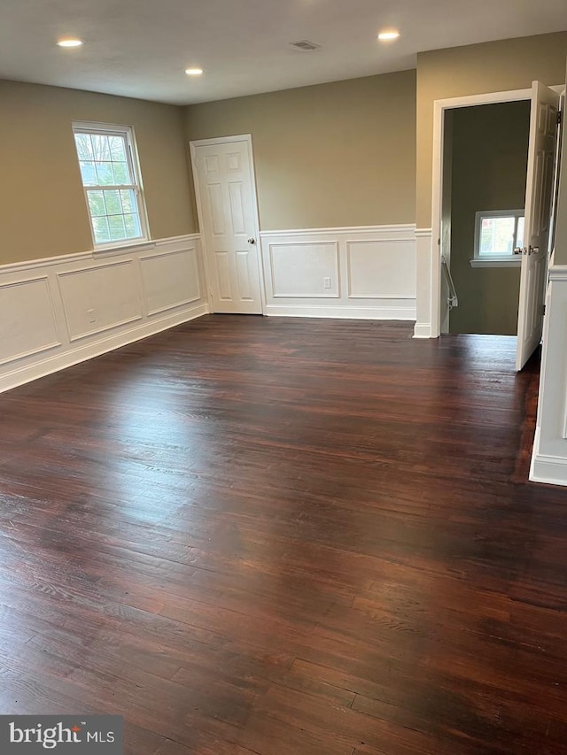 empty room with dark wood-type flooring