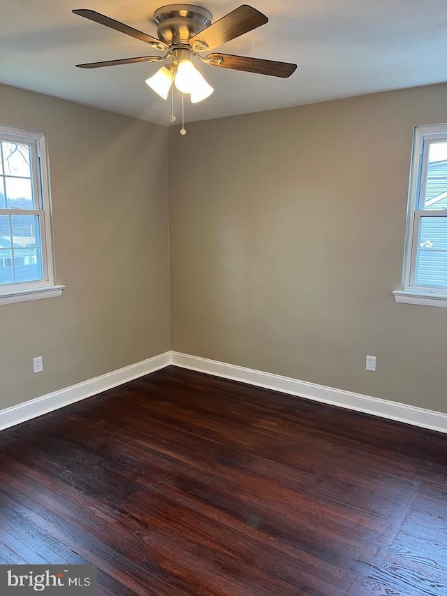 spare room with ceiling fan and dark hardwood / wood-style flooring