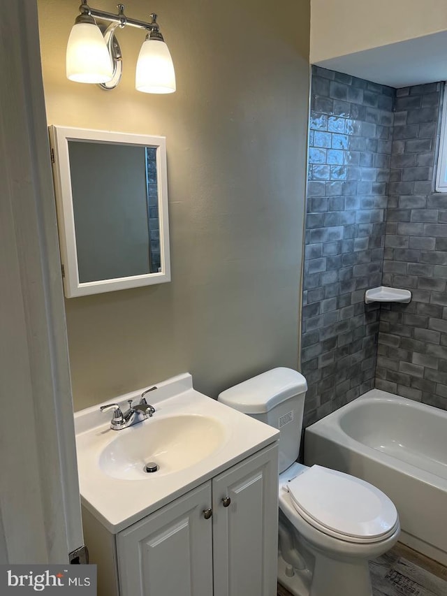 full bathroom with vanity, toilet, and tiled shower / bath combo