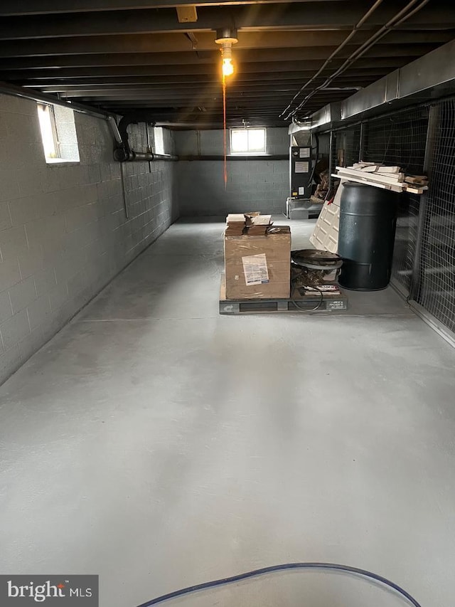 basement with heating unit and a wealth of natural light