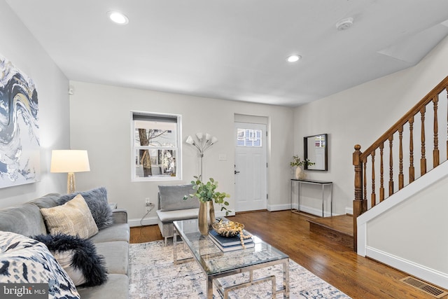 living room with dark hardwood / wood-style flooring