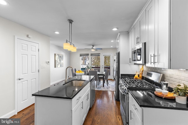 kitchen featuring sink, pendant lighting, appliances with stainless steel finishes, and white cabinets