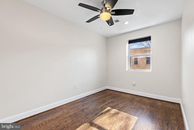 spare room featuring ceiling fan and dark hardwood / wood-style floors