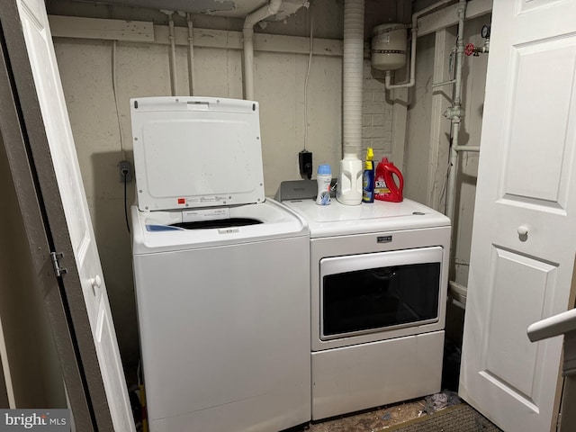 washroom with washing machine and clothes dryer