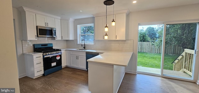 434 Redfern, Hamilton, NJ 08610 - kitchen with appliances with stainless steel finishes, a sink, a peninsula, light countertops, and dark wood finished floors