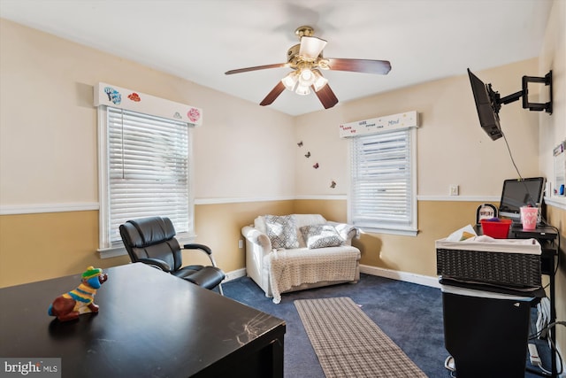 interior space with dark colored carpet and ceiling fan