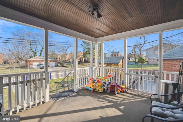 sunroom / solarium featuring wood ceiling