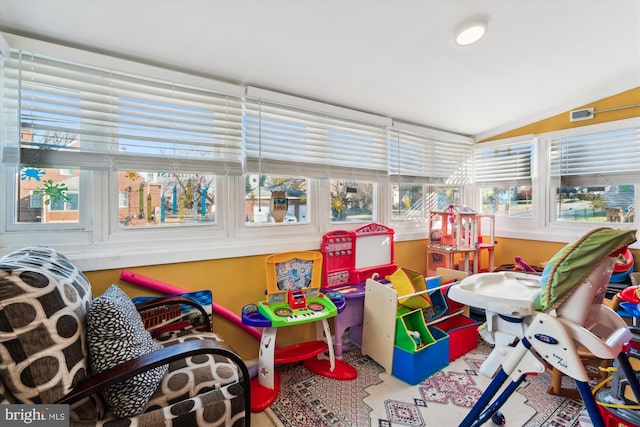 sunroom featuring lofted ceiling