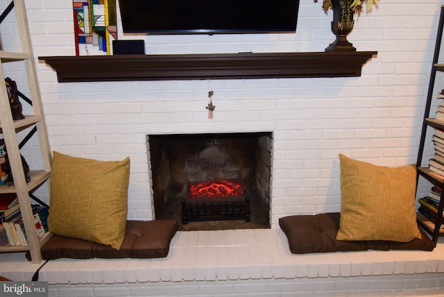 interior details featuring a brick fireplace