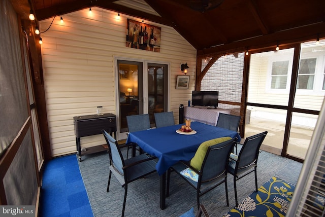 exterior space with vaulted ceiling with beams