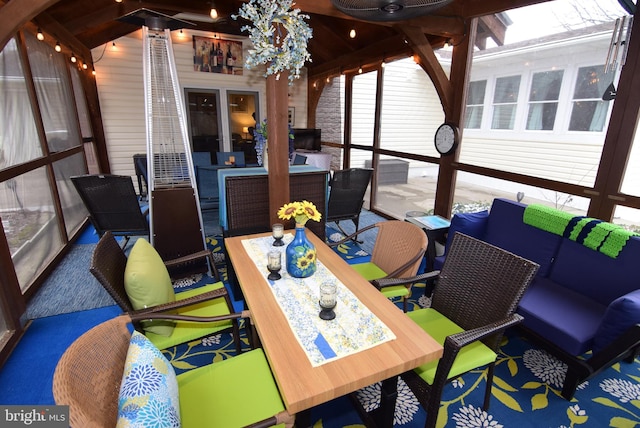 sunroom featuring lofted ceiling