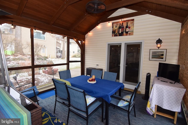 sunroom featuring vaulted ceiling with beams and wooden ceiling