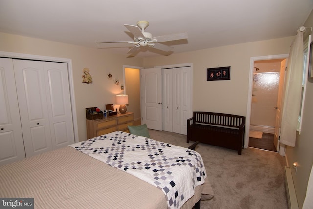 bedroom featuring ceiling fan, a baseboard radiator, light colored carpet, and two closets