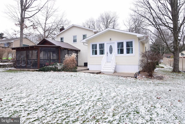 view of front of home featuring a sunroom