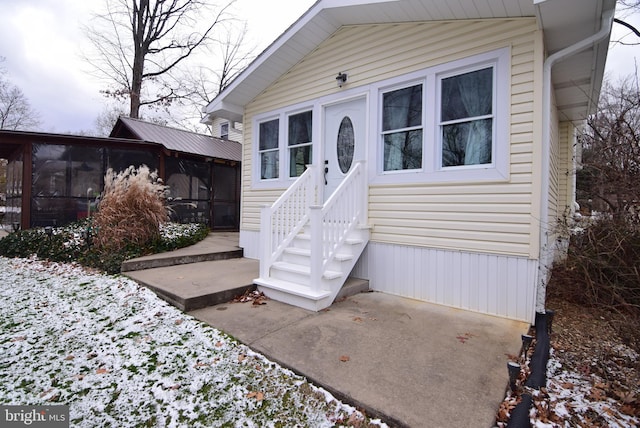 view of snow covered property entrance