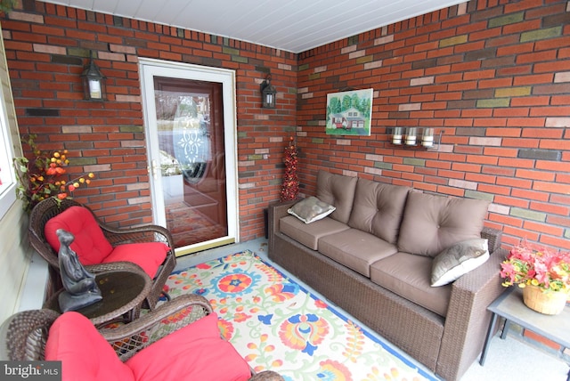 living room featuring brick wall