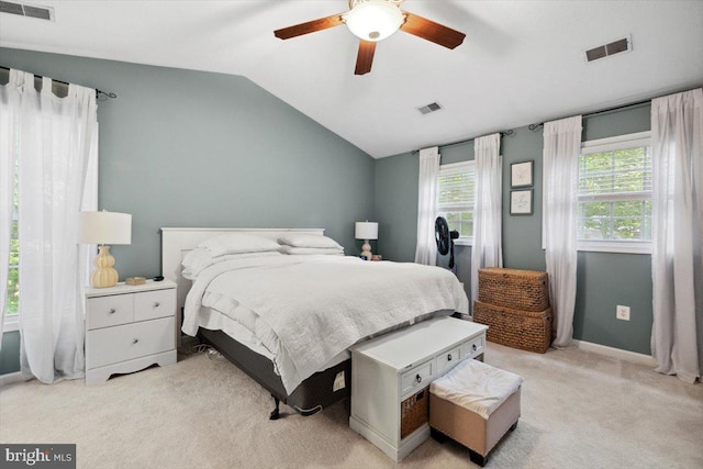 bedroom featuring ceiling fan, light carpet, and vaulted ceiling