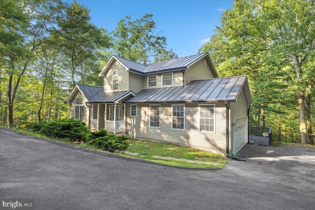 view of front of property featuring a porch and a garage