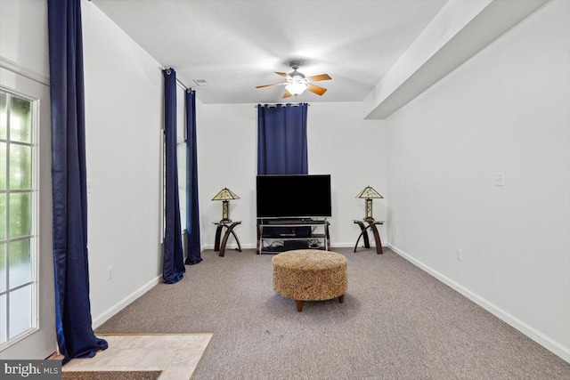 sitting room with carpet flooring and ceiling fan