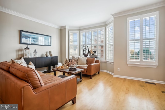 living room with light wood-type flooring and ornamental molding