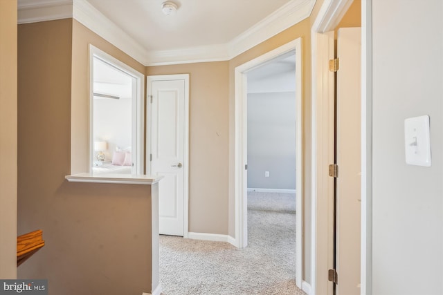 hall with ornamental molding and light carpet