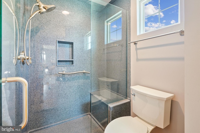 bathroom with an enclosed shower and toilet