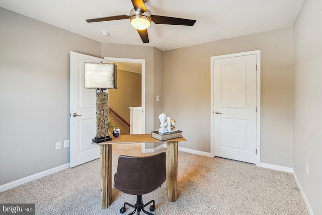 home office with light carpet and ceiling fan