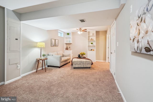 living room with electric panel, ceiling fan, and carpet floors