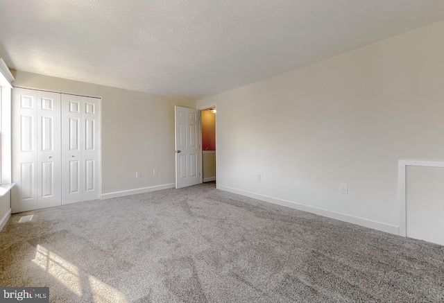 unfurnished bedroom featuring carpet flooring and a closet